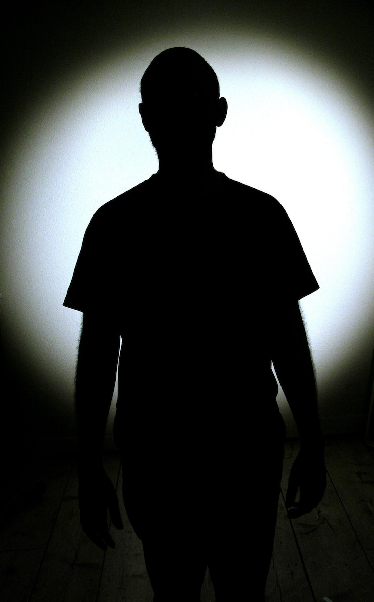 Photo des silhouettes de personnes debout sur un fond blanc