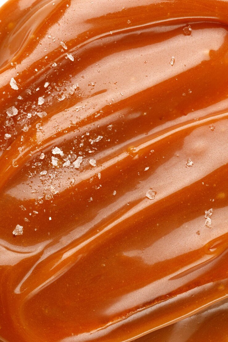 Photo sirop de caramel salé liquide fond de pâte de caramel salé texture close up top view