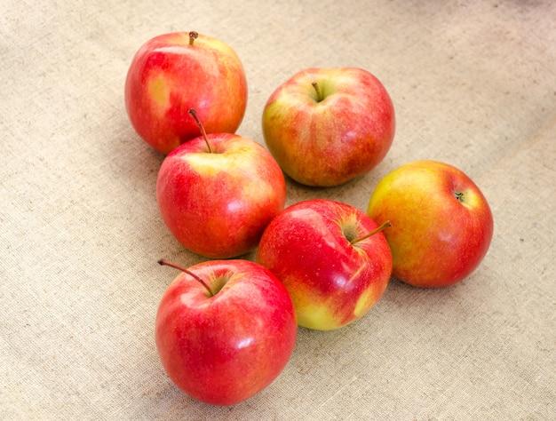 Six juteuses, belles, grosses pommes rouges sur fond blanc.