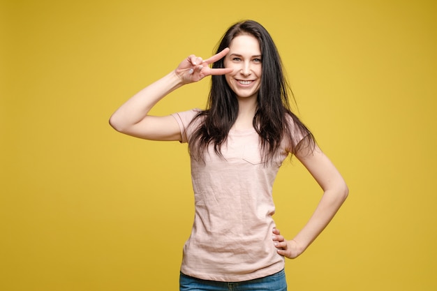 Slim femme portant une chemise beige avec signe de paix