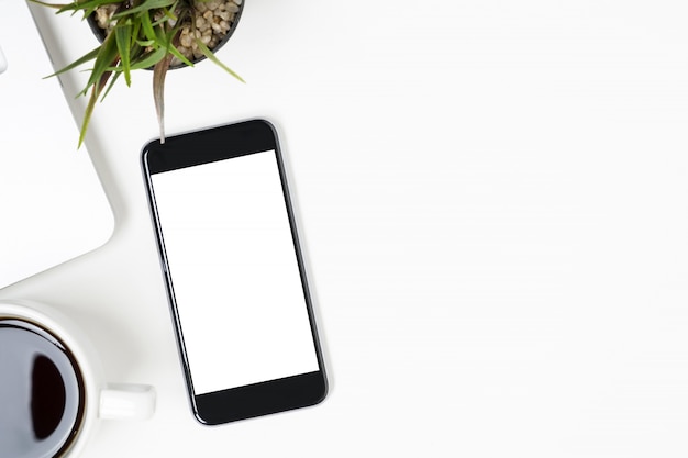 Le smartphone avec écran vide est au-dessus du tableau blanc. Vue de dessus avec espace de copie, pose à plat.