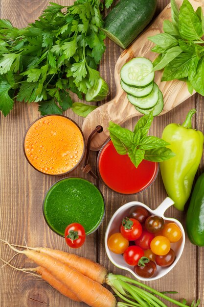 Smoothie aux légumes frais sur table en bois. Tomate, concombre, carotte. Vue de dessus