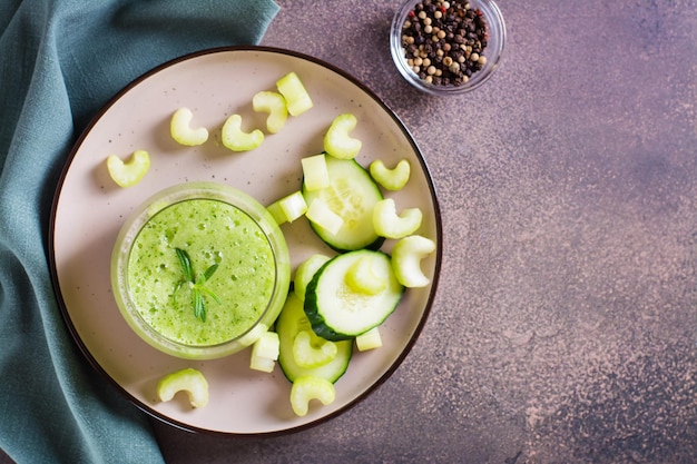 Smoothie vert frais de concombre et de céleri en verre pour la vue supérieure de régime végétarien