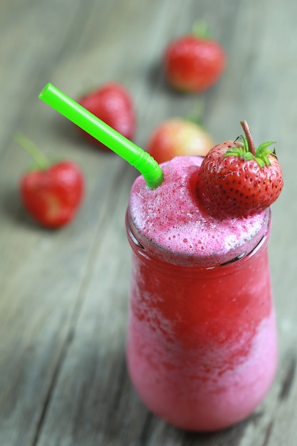 Photo smoothies aux fraises dans le verre sur le sol de la table des aliments.