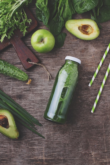 Smoothies verts frais aux épinards, avocat, concombre et pommes. pose à plat.