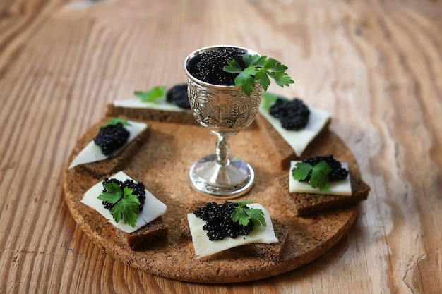 Snack caviar noir sur fond marron en bois