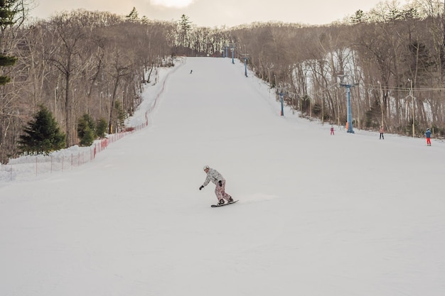 Snowboarder masculin dans une station de ski en hiver