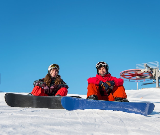 Snowboarders Guy et fille sur la neige