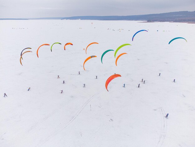 SnowKiting sport de kitesurf sur le lac de glace en hiver. Vue aérienne par drone.