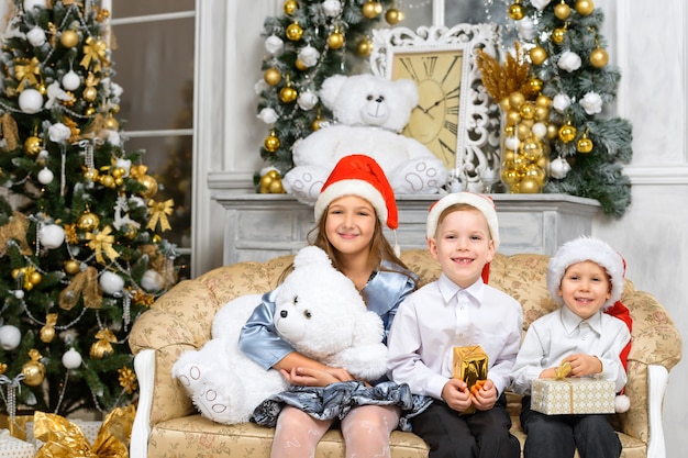 Sœurs et frères avec des coffrets cadeaux de Noël