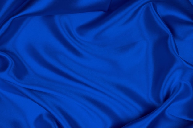 Soie bleue élégante lisse ou texture satin peut utiliser comme arrière-plan abstrait