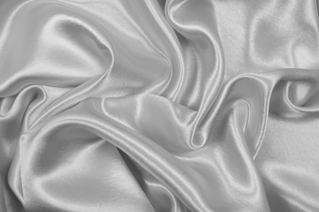 Soie grise élégante lisse ou texture satin peut utiliser comme fond abstrait