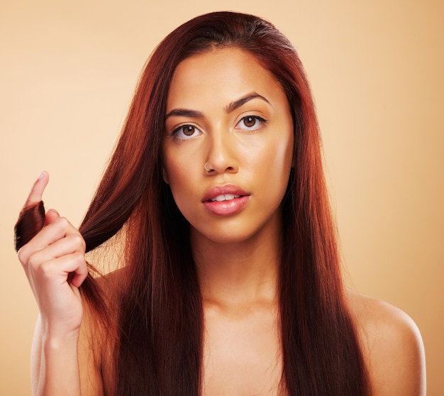 Soins capillaires beauté et portrait d'une femme sérieuse avec les mains sur un traitement de salon de luxe sur fond marron Coupe de cheveux esthétique naturelle et visage de soins capillaires du modèle avec cosmétiques et maquillage en studio