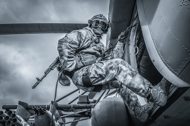 Soldat se prépare à sauter d'un hélicoptère. Le concept de jeux informatiques. Technique mixte