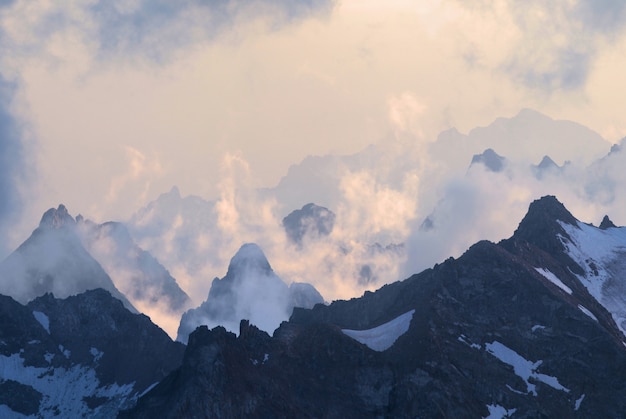 Les sommets des montagnes du Caucase tôt le matin au-dessus des nuages