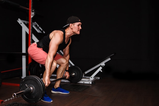 Soulevé de terre. Homme sportif soulevant Barbell Row au gymnase