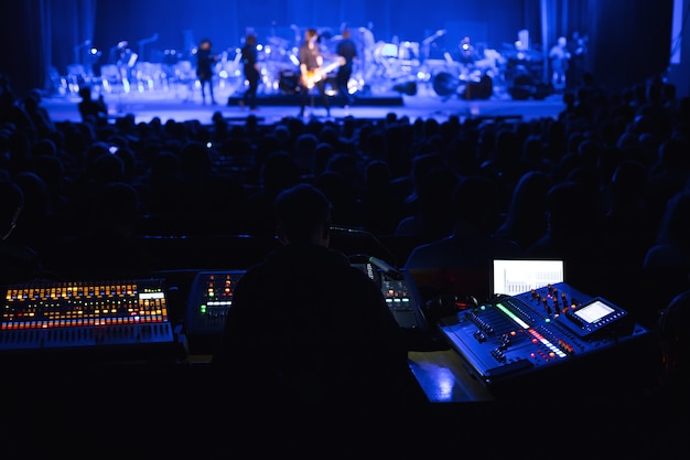 Soundman travaillant sur la console de mixage dans la salle de concert