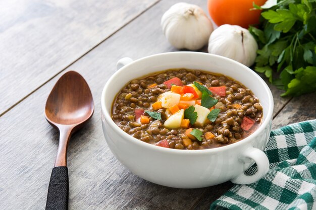 Soupe aux lentilles dans un bol sur la table en bois