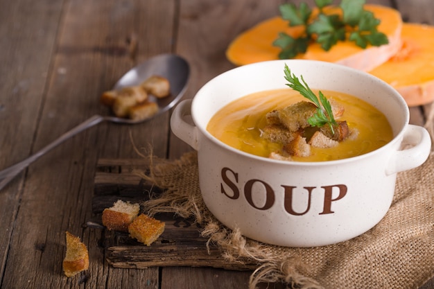 Soupe à la citrouille. Soupe végétarienne aux graines de citrouille dans un bol sur une table en bois, vue du dessus