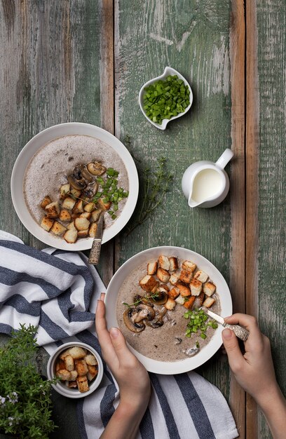 Soupe à la crème aux champignons et croûtons dans un bol blanc