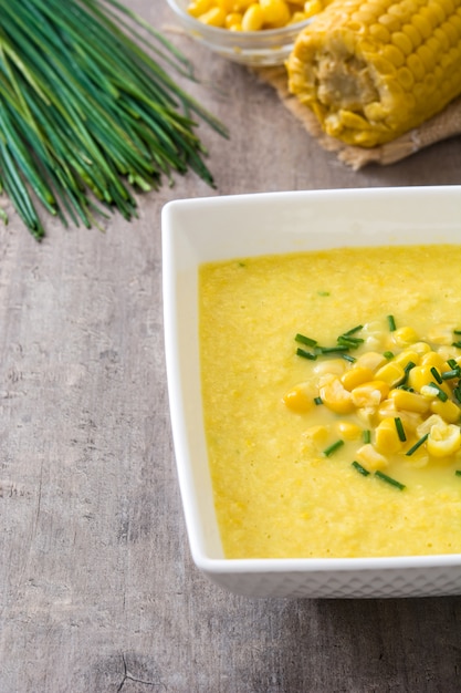 Soupe de maïs dans un bol sur une surface en bois