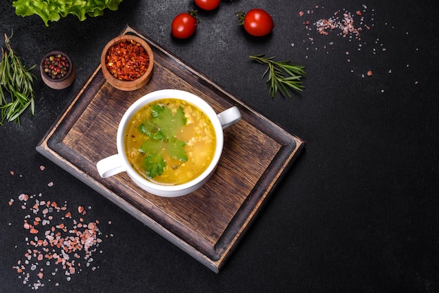 Soupe saine et savoureuse chaude avec du poisson et des légumes servis sur une assiette ronde