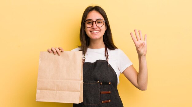 Souriant et amical montrant le numéro quatre