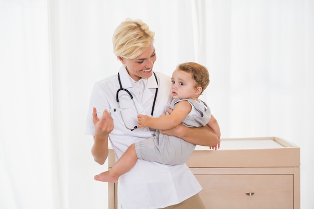 Souriant blonde médecin et enfant avec stéthoscope