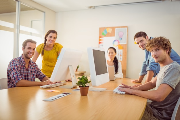 Souriant équipe travaillant sur des ordinateurs portables