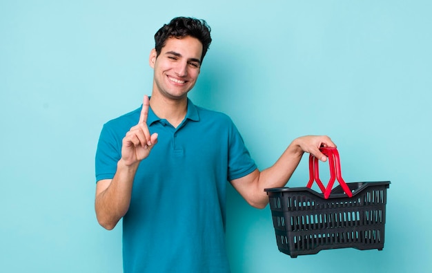 souriant fièrement et avec confiance faisant le numéro un