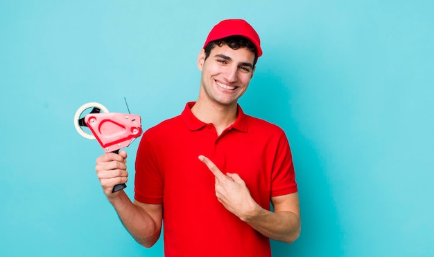 Souriant gaiement se sentant heureux et pointant vers le côté