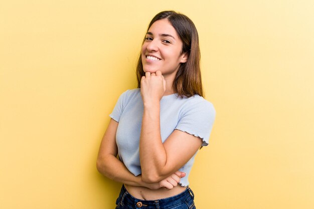 Souriant heureux et confiant touchant le menton avec la main