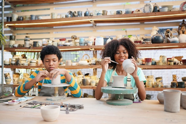 Souriant jeune couple dans un atelier de poterie