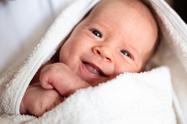 Souriant nouveau-né un mois bébé garçon souriant bébé