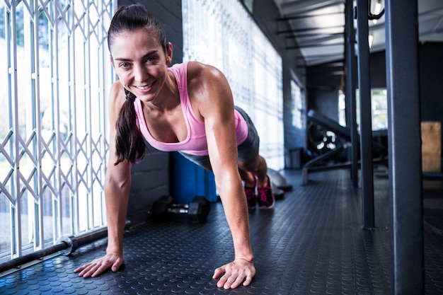 Souriante jeune femme dans la salle de gym