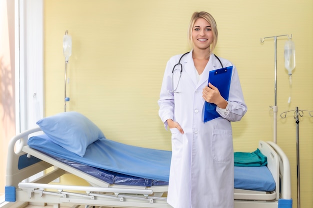 Sourire, caucasien, femme, docteur, tenue, document, fichier, Porter, stéthoscope, hôpital, chambre