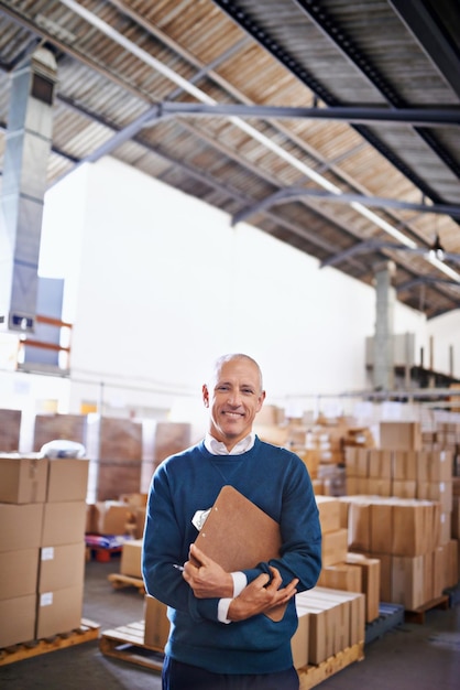 Sourire de livraison et portrait d'un homme dans un entrepôt pour le stockage et l'expédition de marchandises