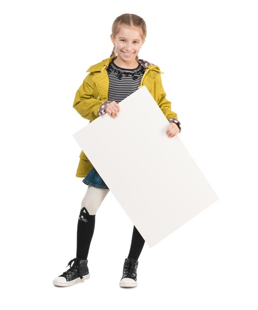 Sourire de petite fille avec une feuille vierge dans les mains