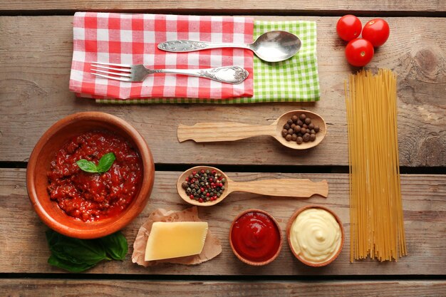 Spaghetti de pâtes à la sauce tomate fromage bolognais et basilic sur fond de bois rustique