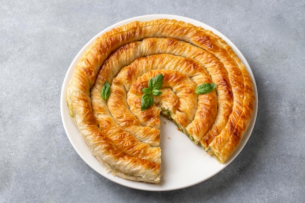 Spanakopita est une tarte à la pâtisserie phyllo grecque avec des épinards et du fromage feta. Des tartes délicieuses faites à la main. Nom turc: el acmasi borek rulo borek.