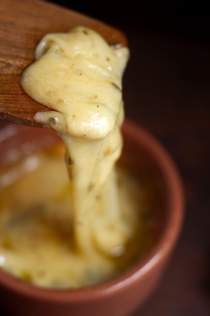 Photo spatule en bois avec fromage fondu