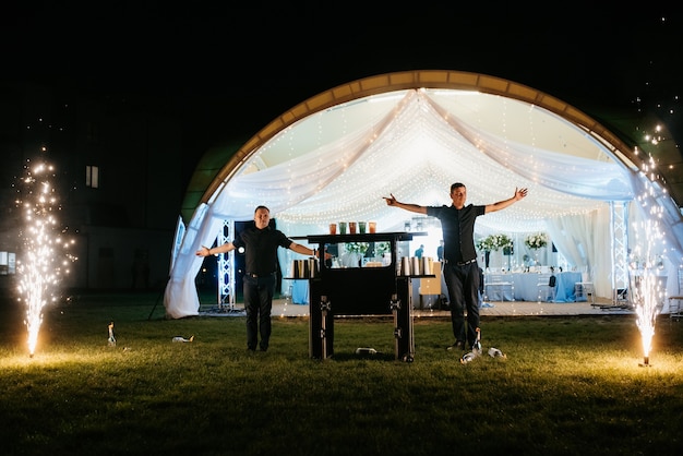 Spectacle de junglers barmans avec des bouteilles avec des torches allumées