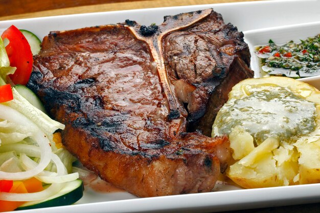 Steak d'os grillé avec salade et pommes de terre