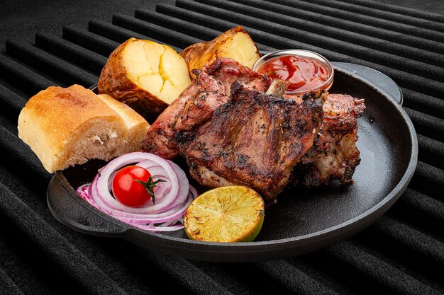 Steak de veau grillé avec matnakash de pommes de terre au four et sauce rouge Servi dans une poêle en fonte