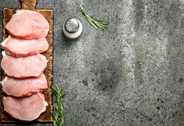 Steaks de porc crus aux herbes et épices.