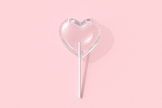 Sucette de bonbons en verre en forme de coeur exceptionnelle sur fond de couleur rose. Rendu 3D. Idée de concept minimal pour la Saint-Valentin.