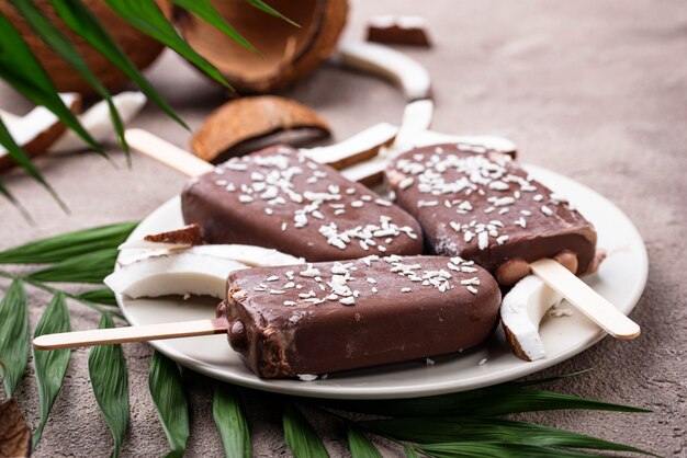 Sucettes glacées à la noix de coco dans un glaçage au chocolat