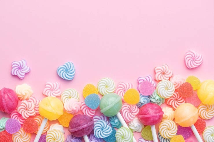 Photo sucettes sucrées et bonbons sur fond rose