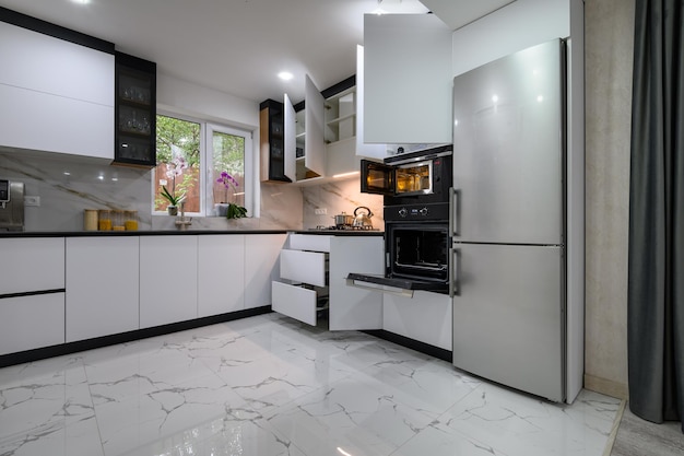 Une superbe cuisine avec un design moderne blanc, un sol en marbre luxueux et des étagères coulissantes