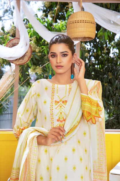 Superbe jeune fille pakistanaise rougissant pour une séance photo de mode portant une robe Desi et Dupatta